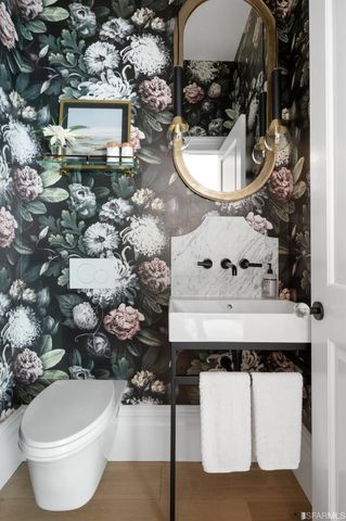 a living room with furniture a lamp paintings and a window