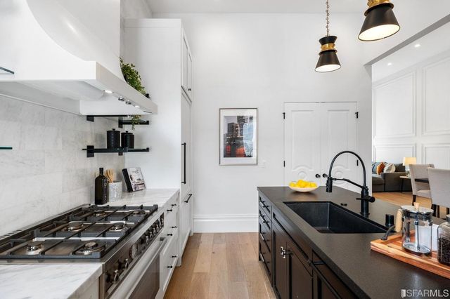 a view of a dining room with furniture and chandelier