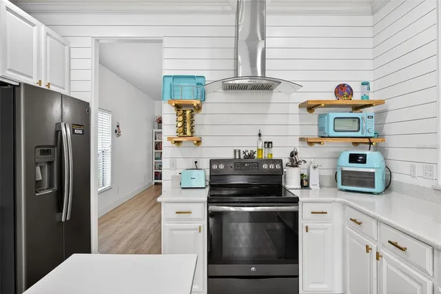 a kitchen with stainless steel appliances and cabinets