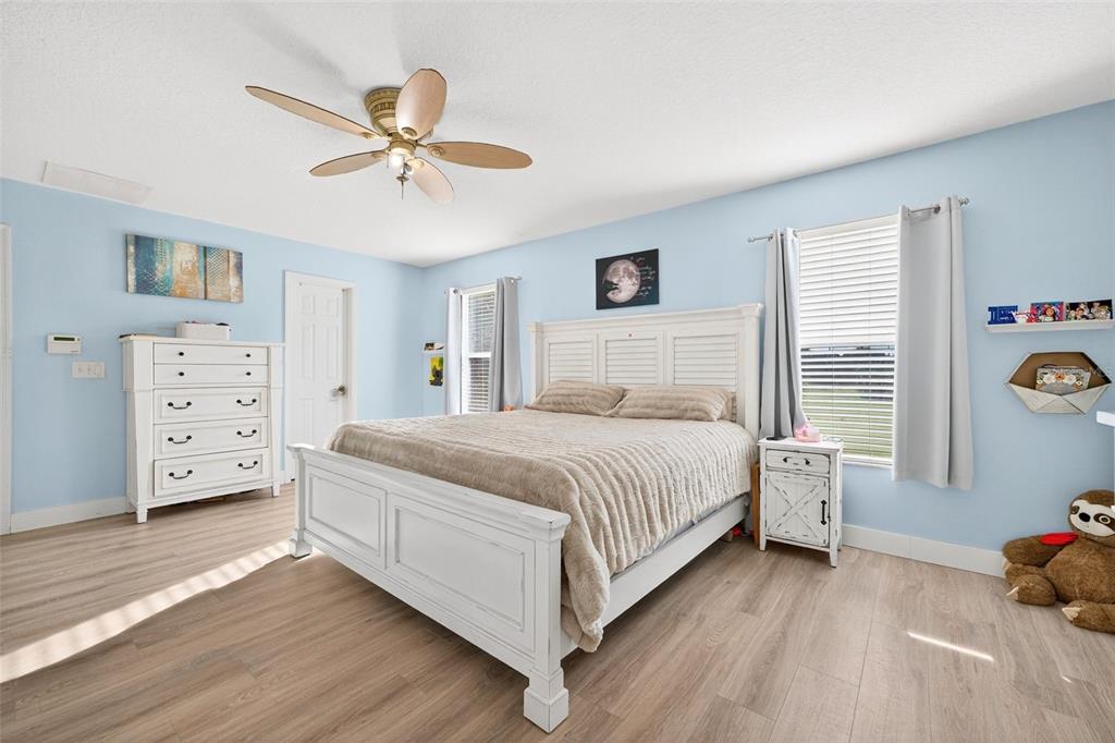 20930 Sullivan Ranch Boulevard Mount Dora, FL 32757 - Photo 19 of 41 a bedroom with a bed and a chandelier