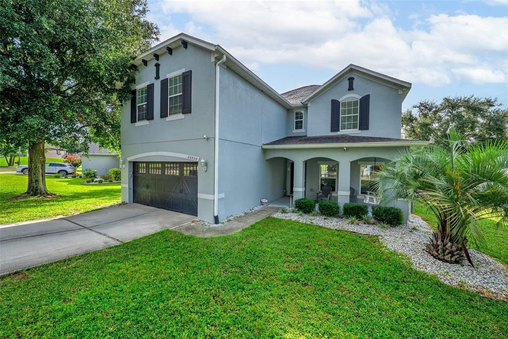 20930 Sullivan Ranch Boulevard Mount Dora, FL 32757 - Photo 2 of 41 a front view of a house with a yard and garage