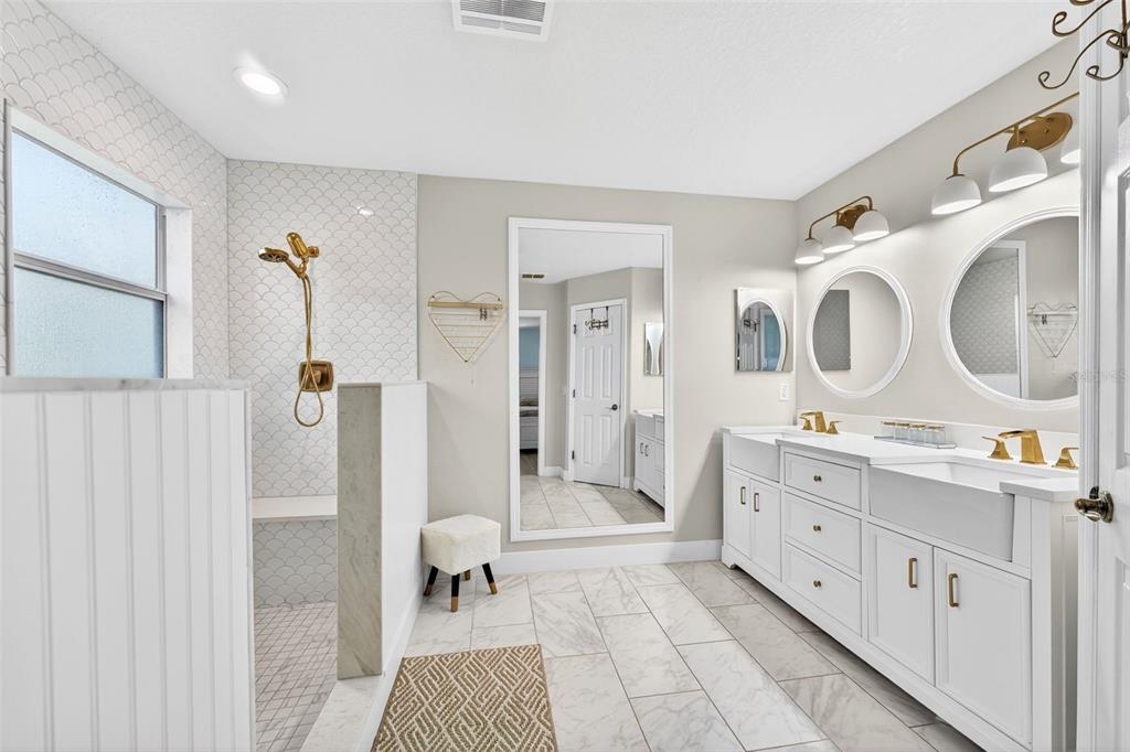 20930 Sullivan Ranch Boulevard Mount Dora, FL 32757 - Photo 21 of 41 a bathroom with a double vanity sink mirror and shower