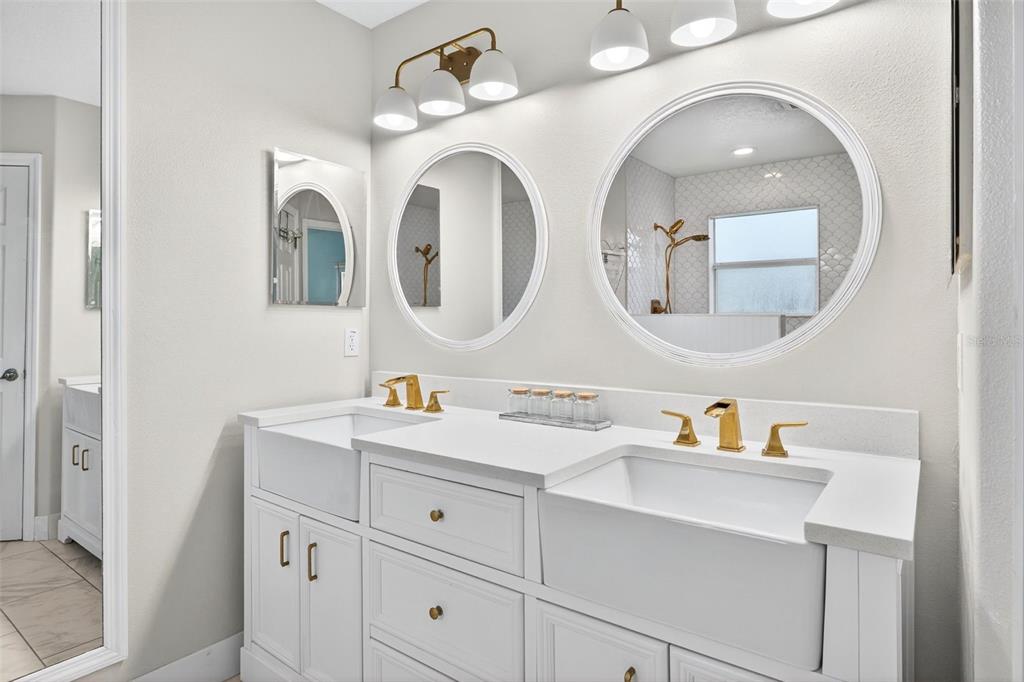 20930 Sullivan Ranch Boulevard Mount Dora, FL 32757 - Photo 22 of 41 a bathroom with a double vanity sink and a mirror