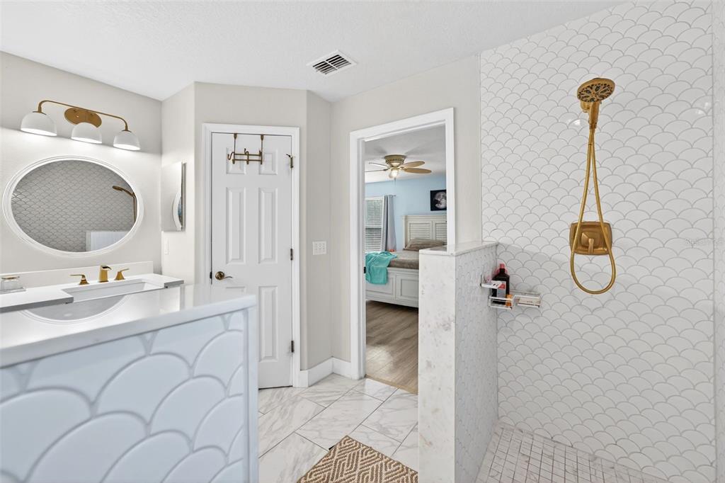 20930 Sullivan Ranch Boulevard Mount Dora, FL 32757 - Photo 26 of 41 a bathroom with a sink and a mirror