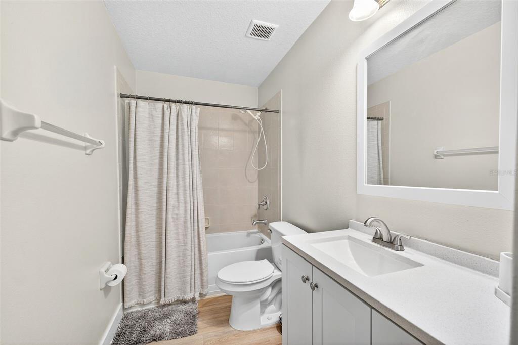 20930 Sullivan Ranch Boulevard Mount Dora, FL 32757 - Photo 28 of 41 a bathroom with a sink a toilet and shower