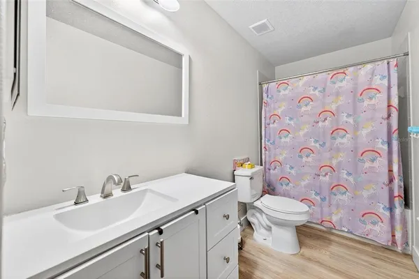 a bathroom with a sink toilet and a mirror