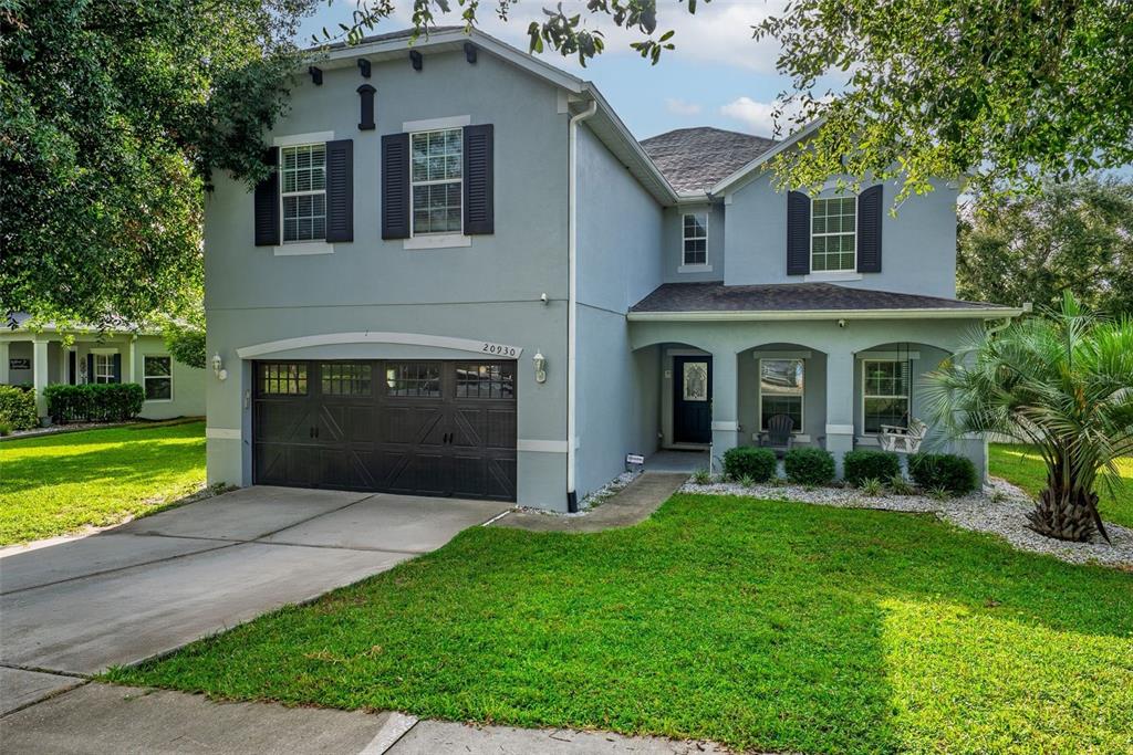 20930 Sullivan Ranch Boulevard Mount Dora, FL 32757 - Photo 3 of 41 a front view of a house with garden