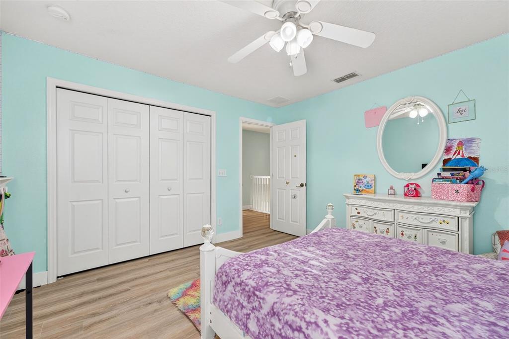 20930 Sullivan Ranch Boulevard Mount Dora, FL 32757 - Photo 32 of 41 a bedroom with a bed and a chandelier