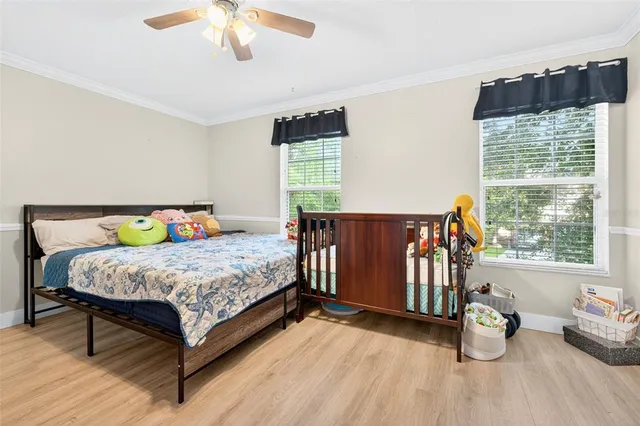 a bedroom with a bed and wooden floor