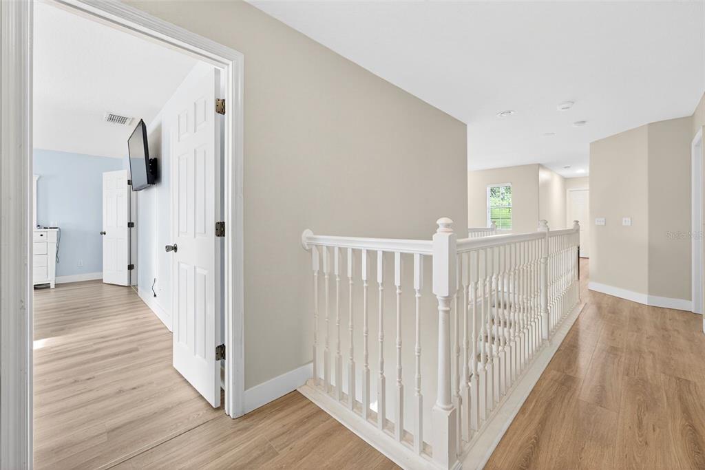 20930 Sullivan Ranch Boulevard Mount Dora, FL 32757 - Photo 35 of 41 a view of a hallway with wooden floor and staircase