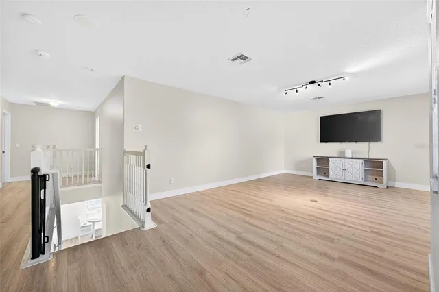 a view of a livingroom with an empty space and a flat screen tv