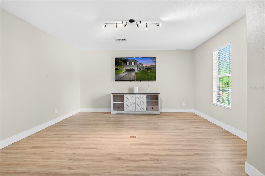 20930 Sullivan Ranch Boulevard Mount Dora, FL 32757 - Photo 38 of 41 a view of an empty room with wooden floor and a window