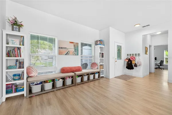 a living room with furniture and wooden floor