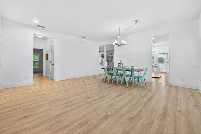 a dining room with furniture and wooden floor