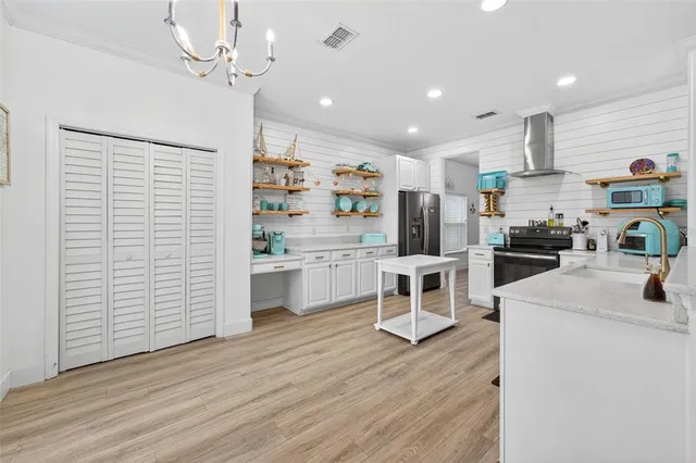 a kitchen with white cabinets and white appliances