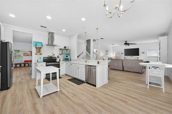 a kitchen with a sink cabinets and wooden floor