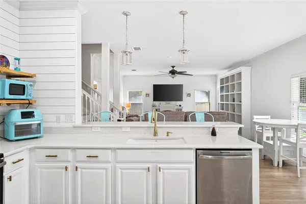 a kitchen with stainless steel appliances kitchen island granite countertop a sink and a microwave