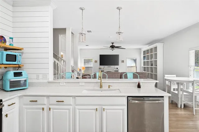 a kitchen with stainless steel appliances kitchen island granite countertop a sink and a microwave