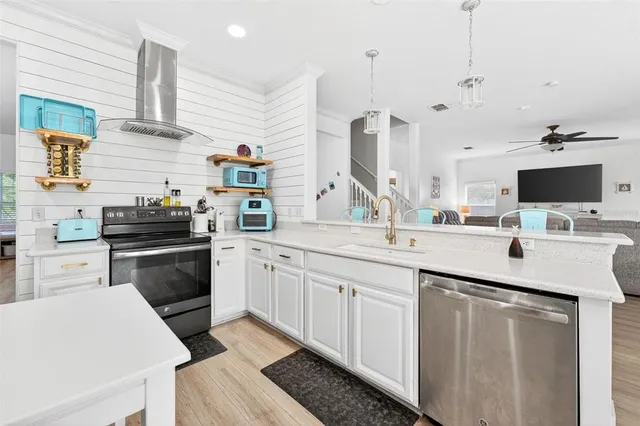 a kitchen with a sink stove and microwave