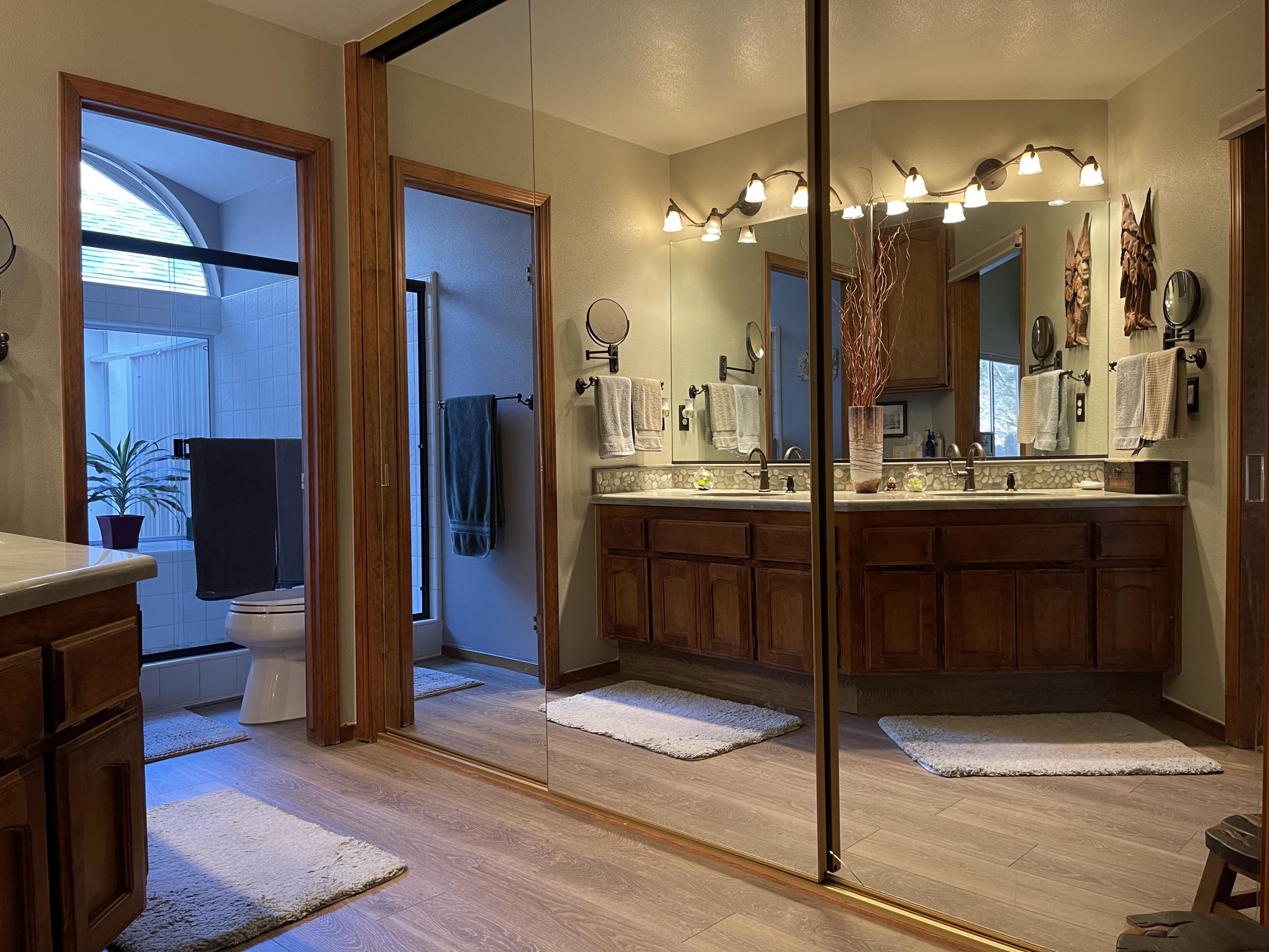 40964 Cherokee Oaks Drive Three Rivers, CA 93271 - Photo 18 of 41 a bathroom with a sink a large mirror and a shower