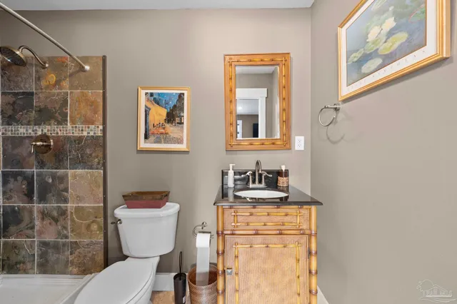 a living room with furniture ceiling fan and a rug