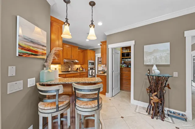 a kitchen with stainless steel appliances granite countertop a refrigerator a stove and a sink