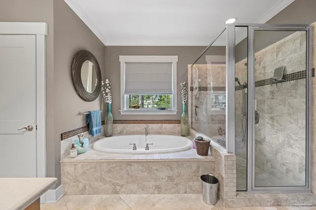 an aerial view of a house with a yard and a large tree