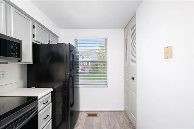 a kitchen with a refrigerator and a stove