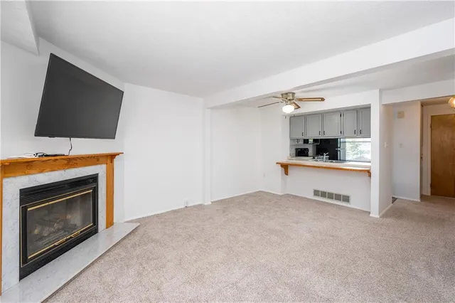 a view of kitchen with microwave stove and cabinets