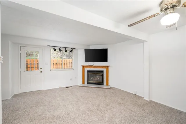 a view of empty room with a fireplace