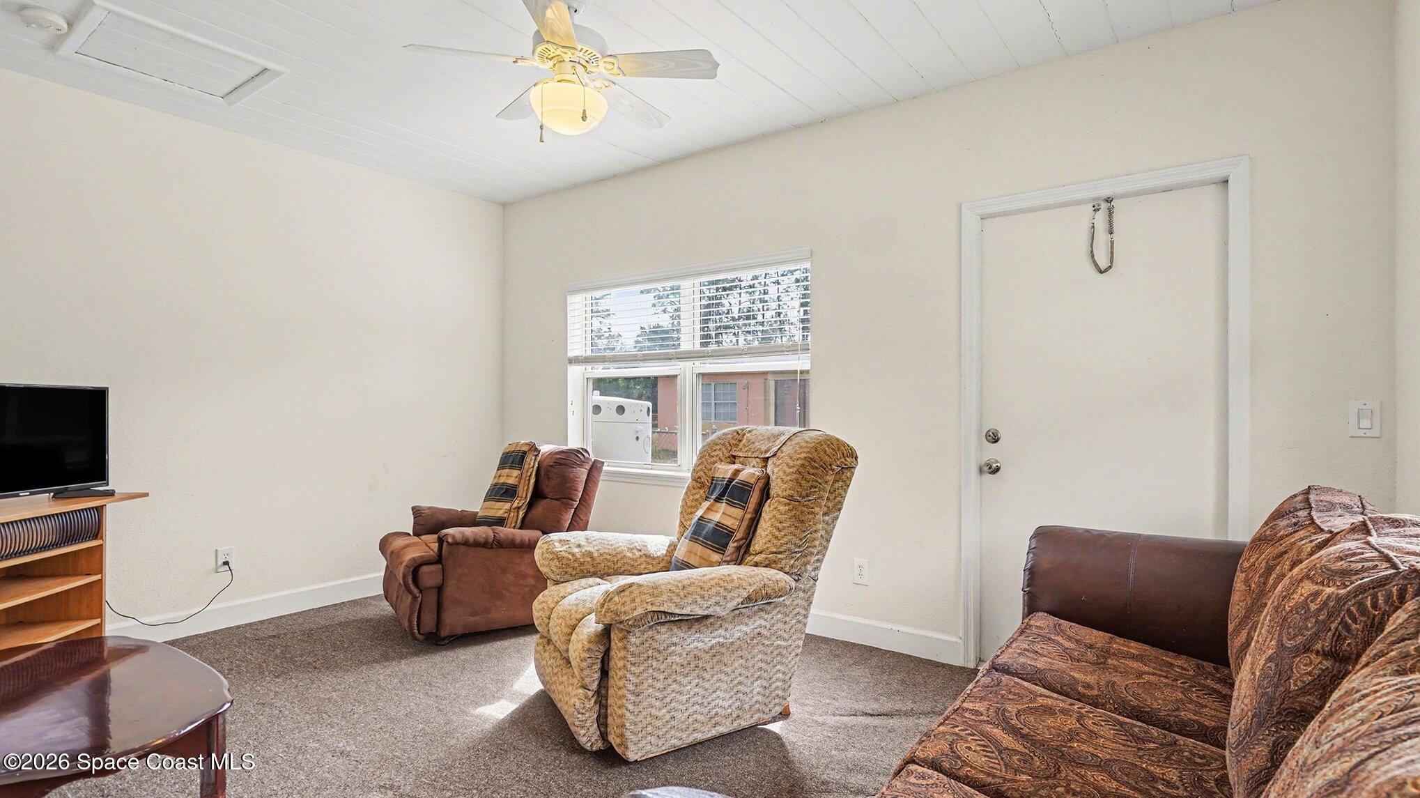 136 Gray Road Melbourne, FL 32904 - Photo 13 of 27 a living room with furniture and a flat screen tv