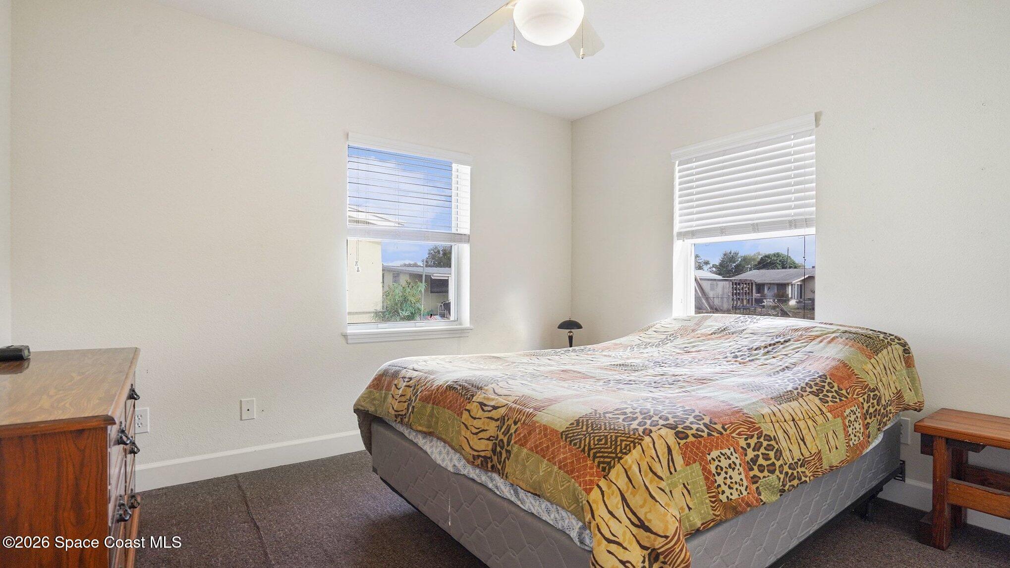 136 Gray Road Melbourne, FL 32904 - Photo 15 of 27 a bedroom with a bed and a window