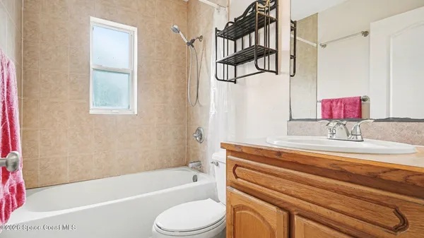 a bathroom with a sink a toilet and bathtub