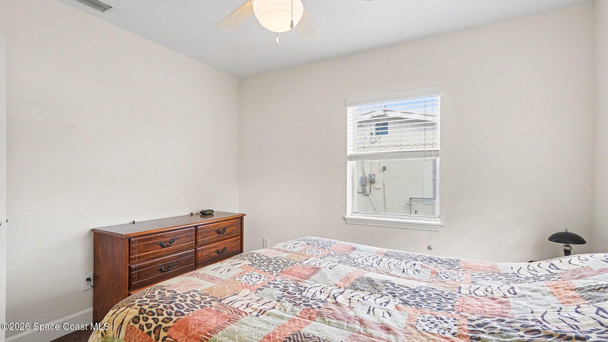 136 Gray Road Melbourne, FL 32904 - Photo 17 of 27 a bedroom with a bed and a window