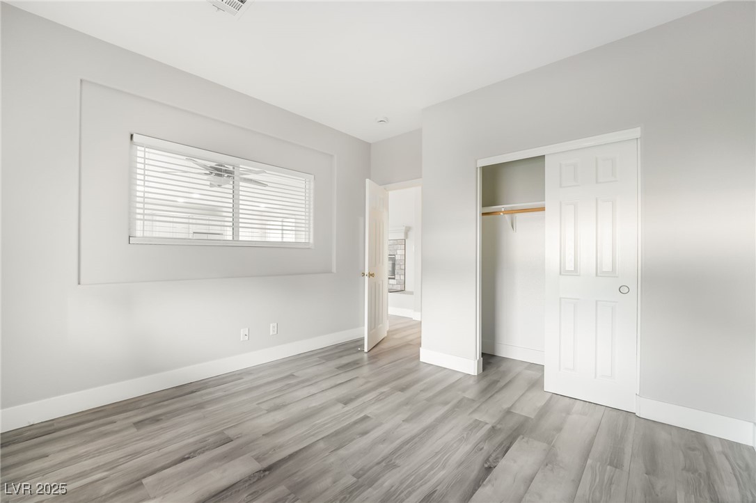 1533 Sabatini Drive Henderson, NV 89052 - Photo 12 of 27 Unfurnished bedroom featuring light wood-style floors and a closet