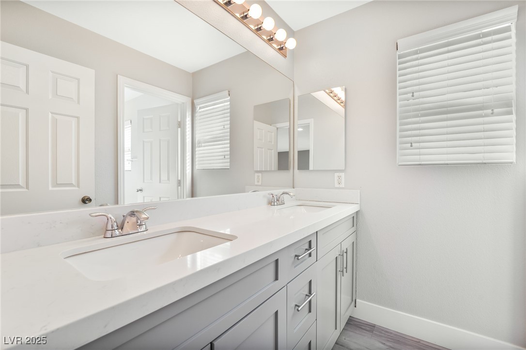 1533 Sabatini Drive Henderson, NV 89052 - Photo 13 of 27 Bathroom featuring double vanity and wood finished floors