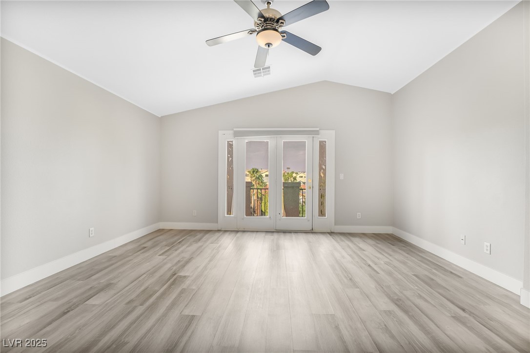 1533 Sabatini Drive Henderson, NV 89052 - Photo 19 of 27 Empty room with light wood-style floors, a ceiling fan, and vaulted ceiling