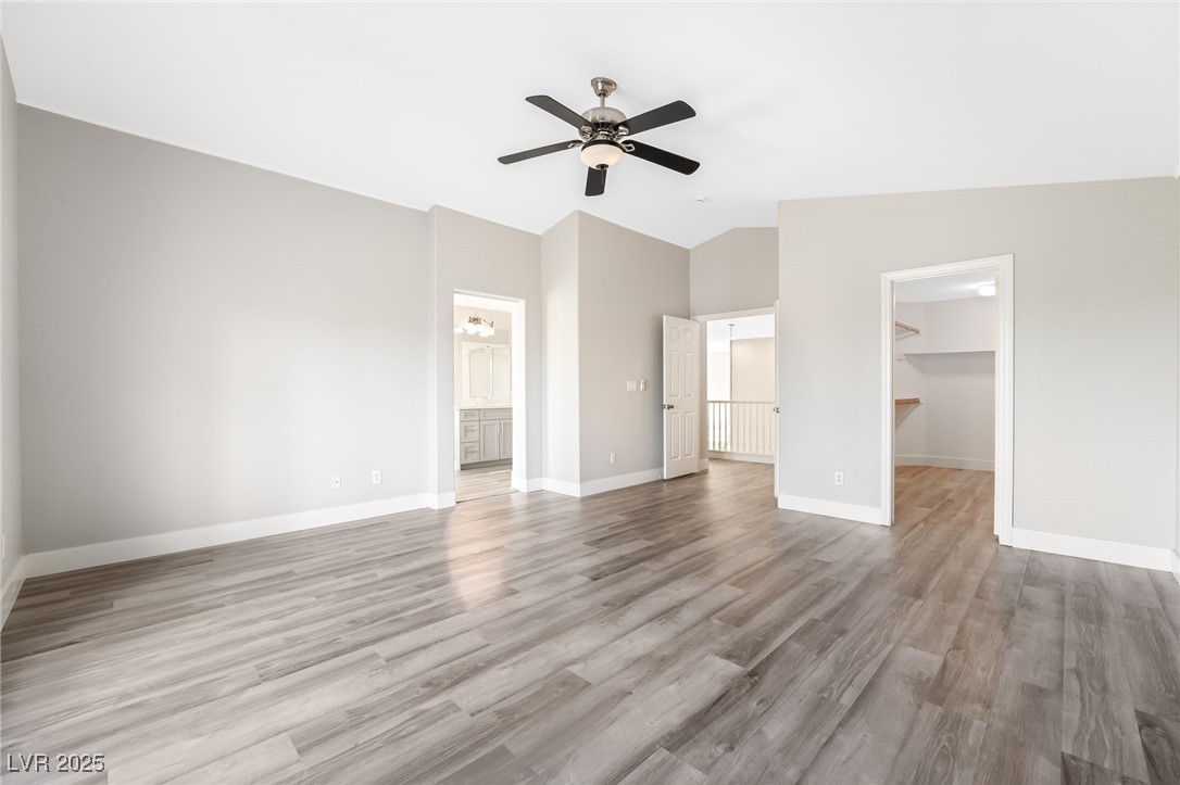 1533 Sabatini Drive Henderson, NV 89052 - Photo 20 of 27 Unfurnished bedroom with light wood finished floors, a walk in closet, a ceiling fan, and vaulted ceiling