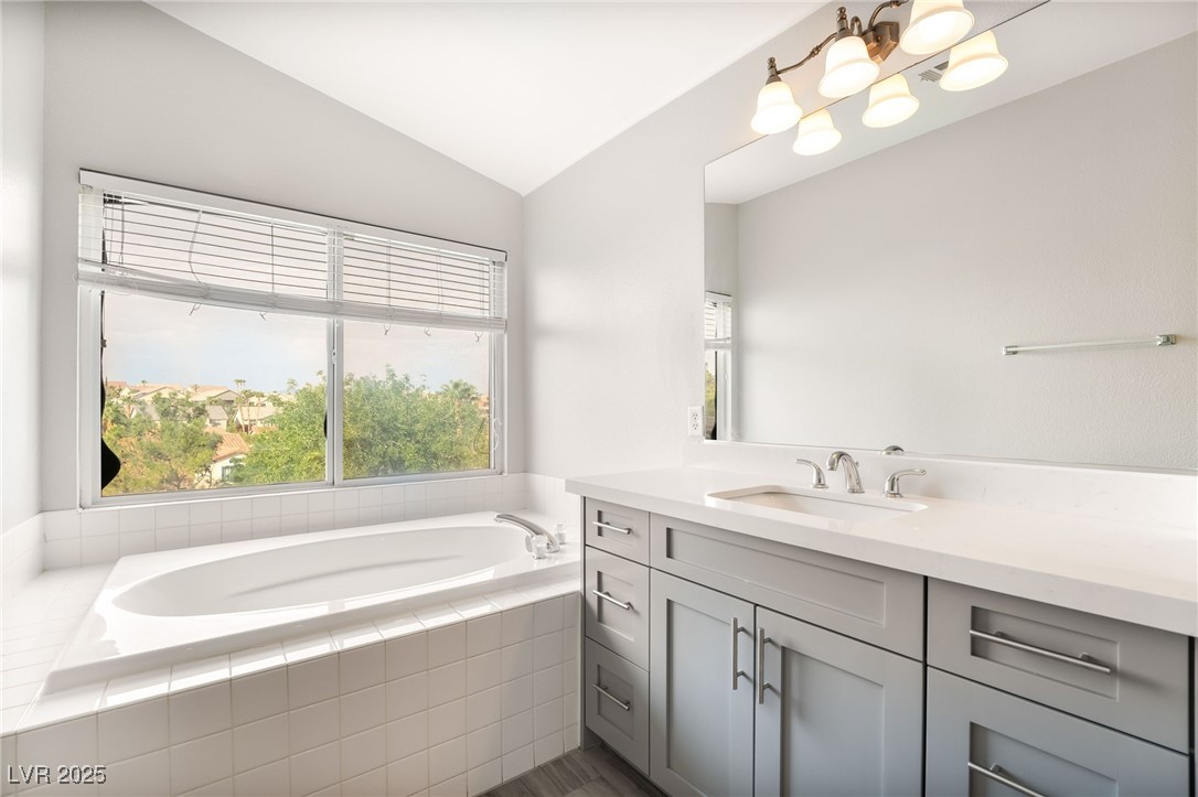 1533 Sabatini Drive Henderson, NV 89052 - Photo 23 of 27 Bathroom featuring lofted ceiling, vanity, and a garden tub