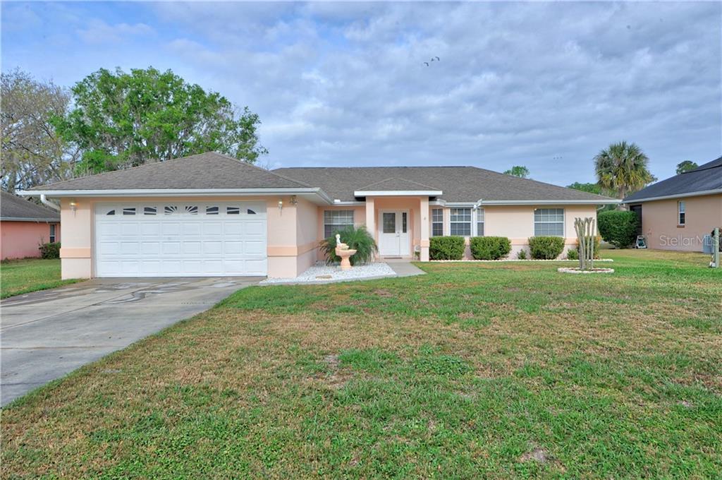 12126 Southeast 60th Avenue Road Belleview, FL 34420 - Photo 1 of 1 a front view of a house with a yard
