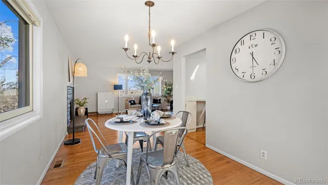a view of a dining room with furniture and a chandelier
