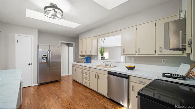 a kitchen with a stove a sink and a refrigerator