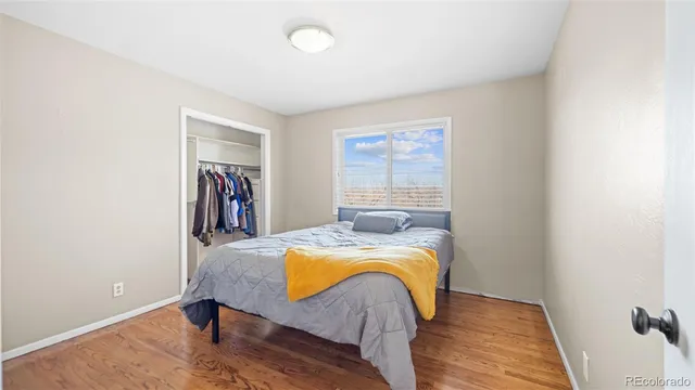 a bed sitting in a bedroom next to a window