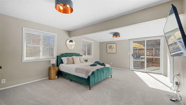 a living room with a bed furniture and a window