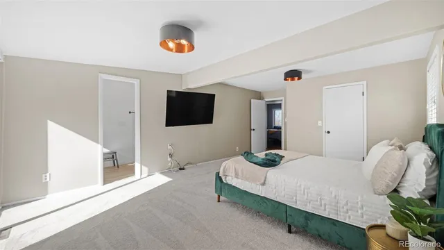 a bedroom with a bed and a flat screen tv