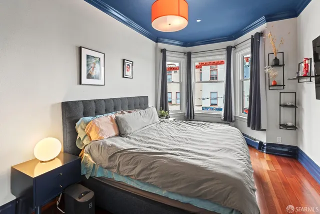 a bedroom with a bed and dresser with mirror