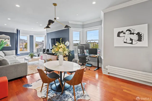 a view of a dining room with furniture window and wooden floor