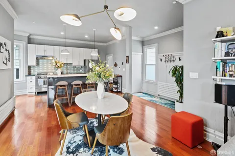 a view of a dining room with furniture and wooden floor