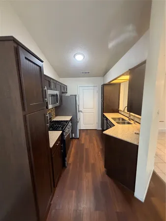 a kitchen with stainless steel appliances a refrigerator stove and microwave