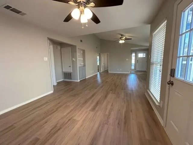 wooden floor in an empty room with a window